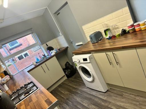 Modern and well-lit kitchen featuring ample cou...