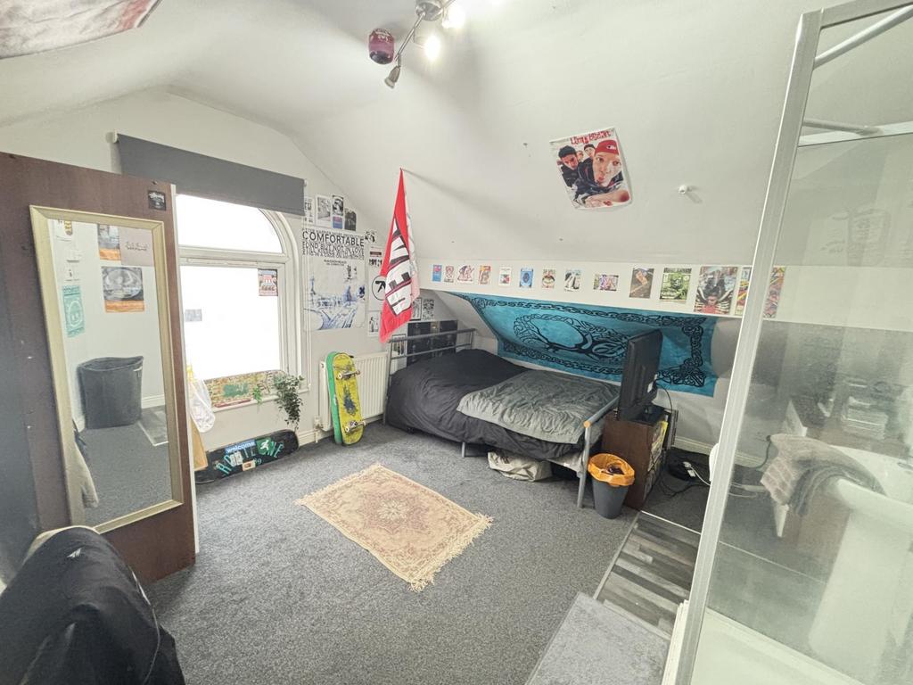 A well-lit, comfortable living room featuring a...