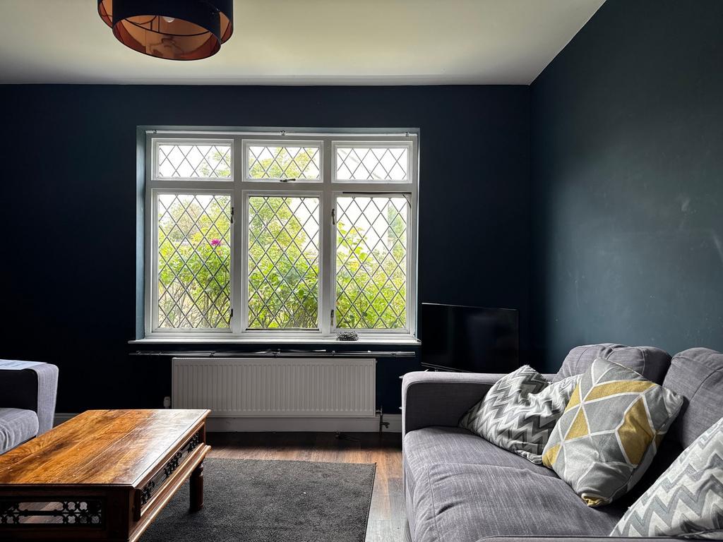 Well-styled living room with a large leaded-win...