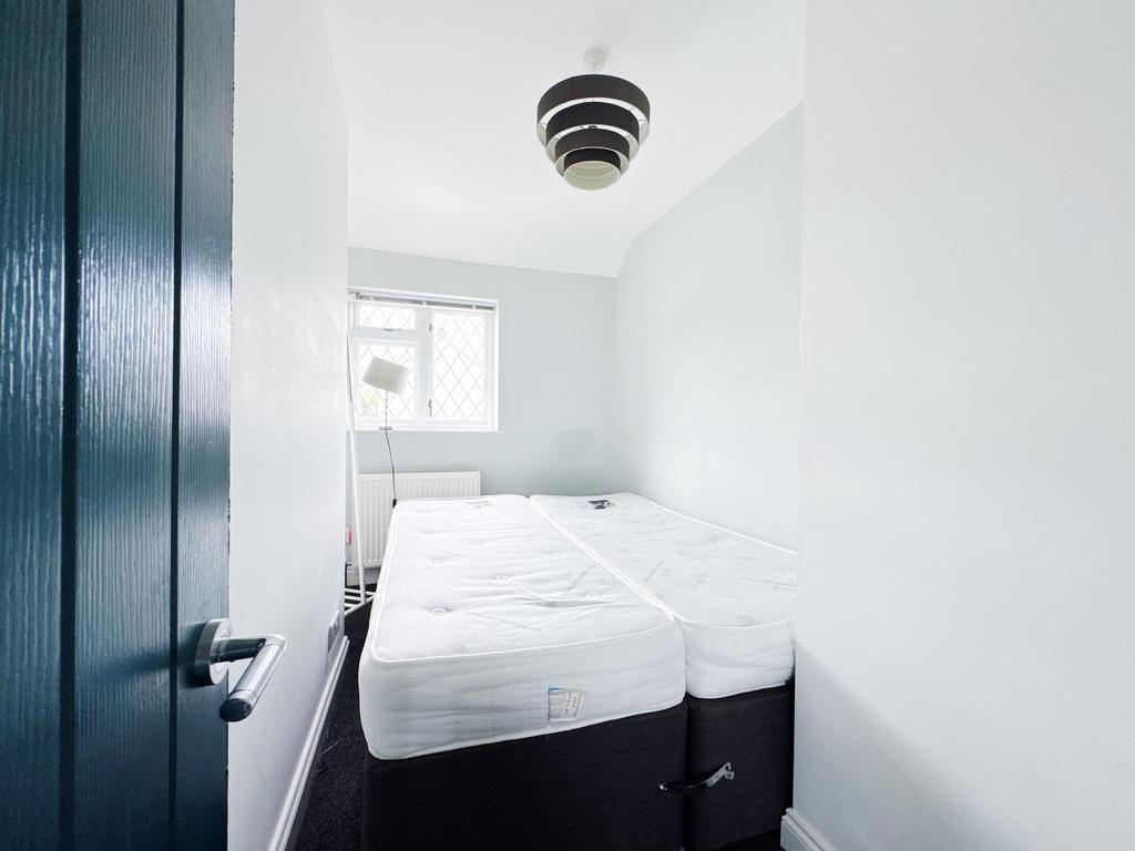 Bright, freshly painted small bedroom with two ...