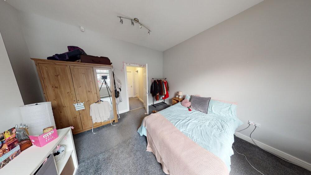 A cozy single bedroom with a comfortable bed, a...