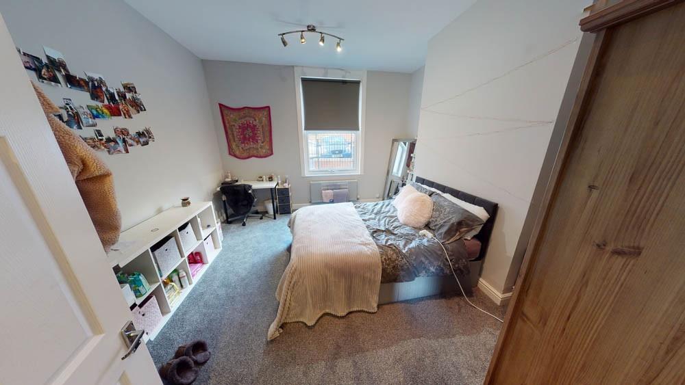 A spacious and inviting master bedroom featurin...
