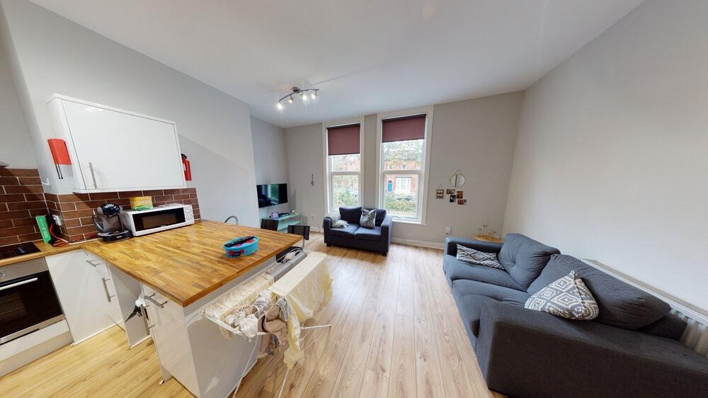 Bright and spacious living room featuring large...