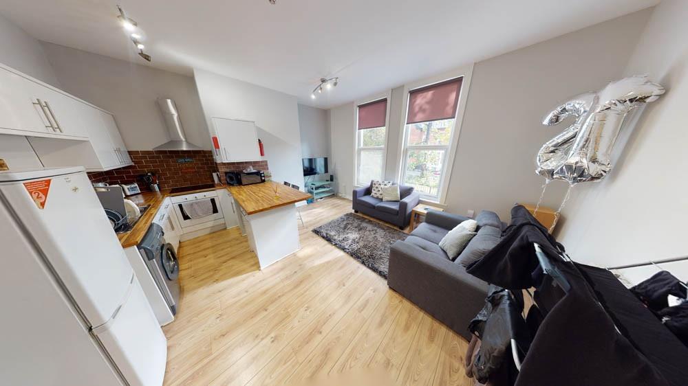 A spacious, modern living room filled with natu...
