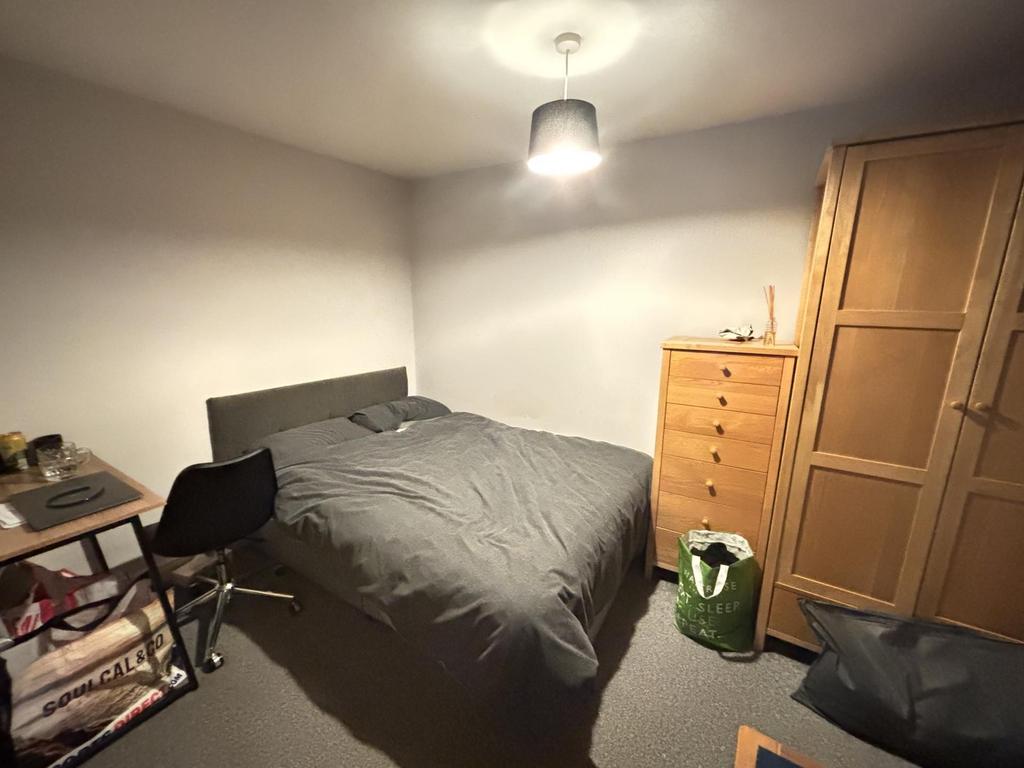 A cozy bedroom featuring a large bed with a stu...