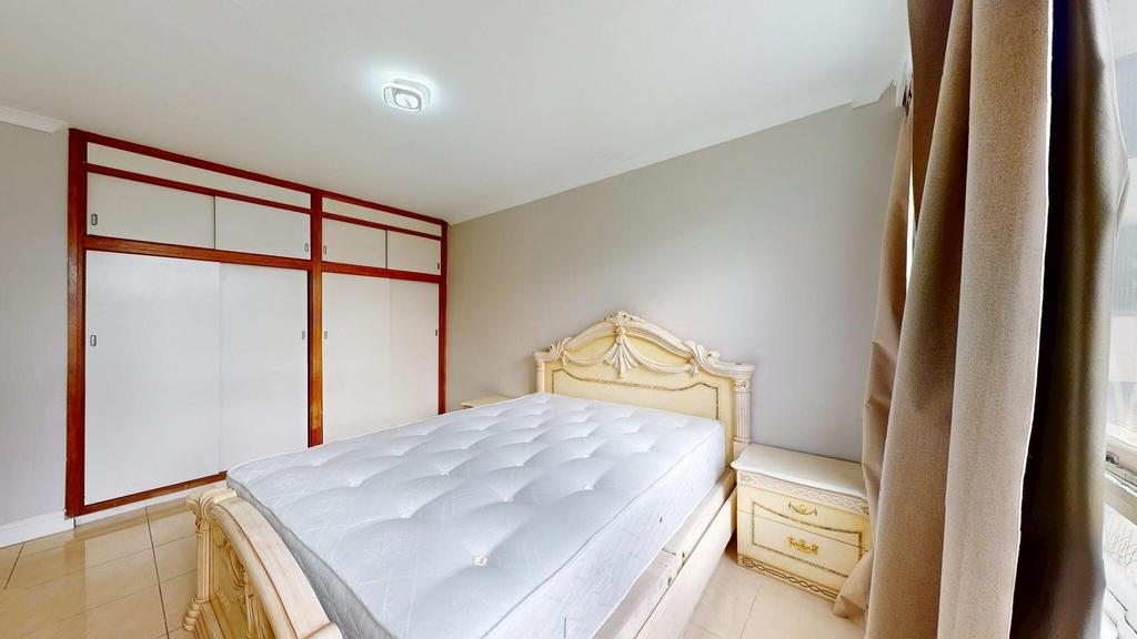 A spacious master bedroom featuring a large, or...