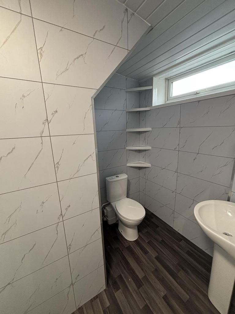 A clean and modern bathroom featuring a toilet ...