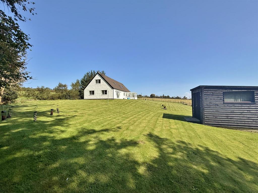 Front garden and wooded area
