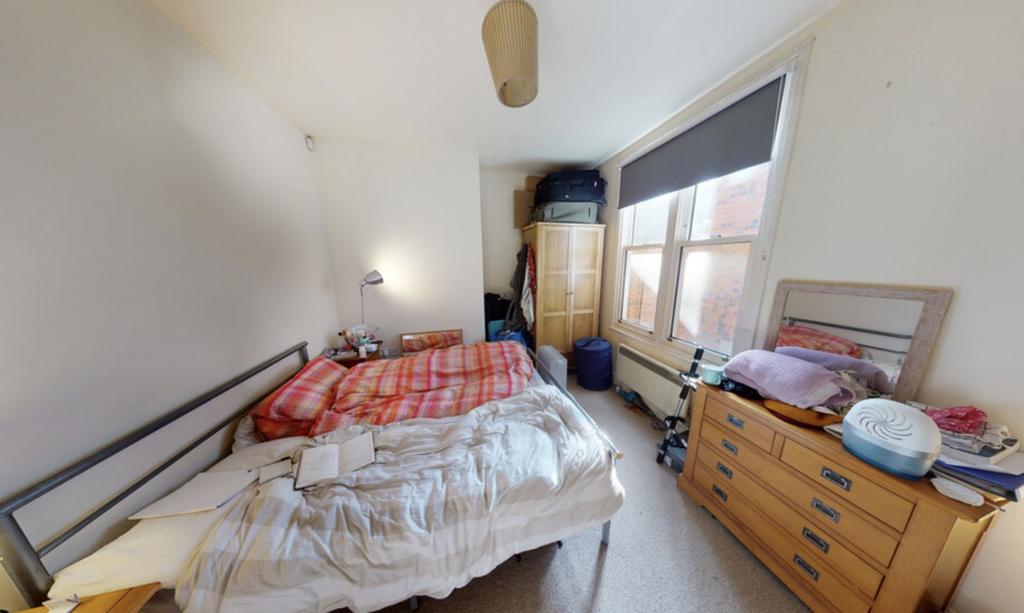 A cozy bedroom featuring a double bed, a bedsid...
