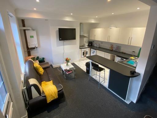 A bright and modern living room featuring comfo...