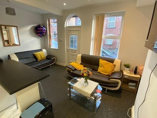 A well-lit, spacious living room with contempor...