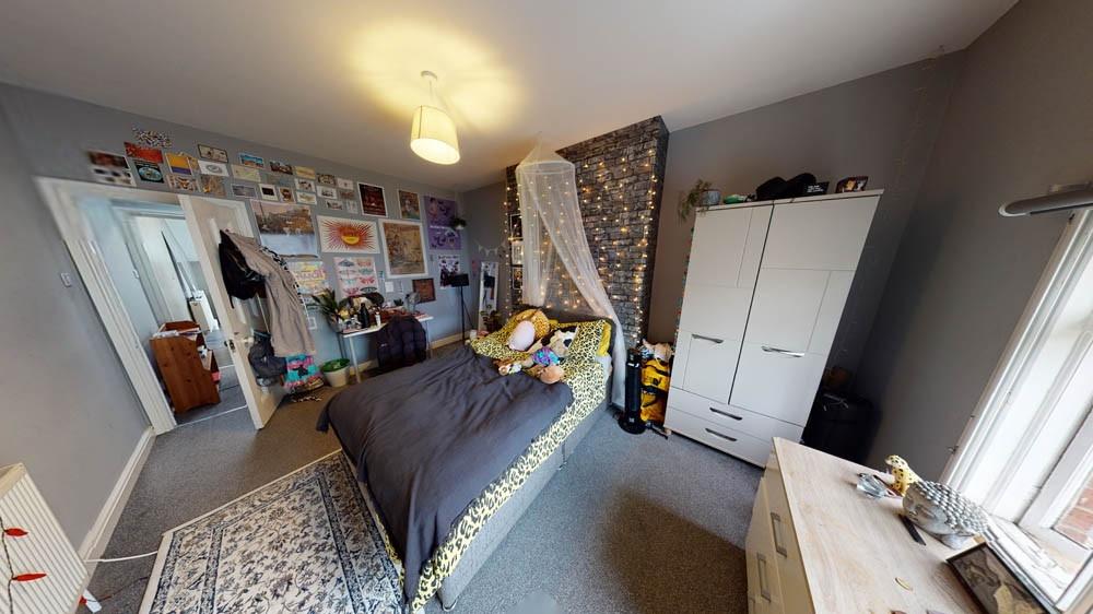 A spacious and well-lit master bedroom featurin...