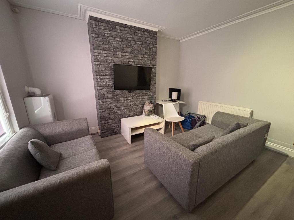 A modern, well-lit living room featuring two co...