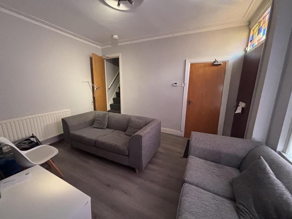 A bright and welcoming living room featuring co...