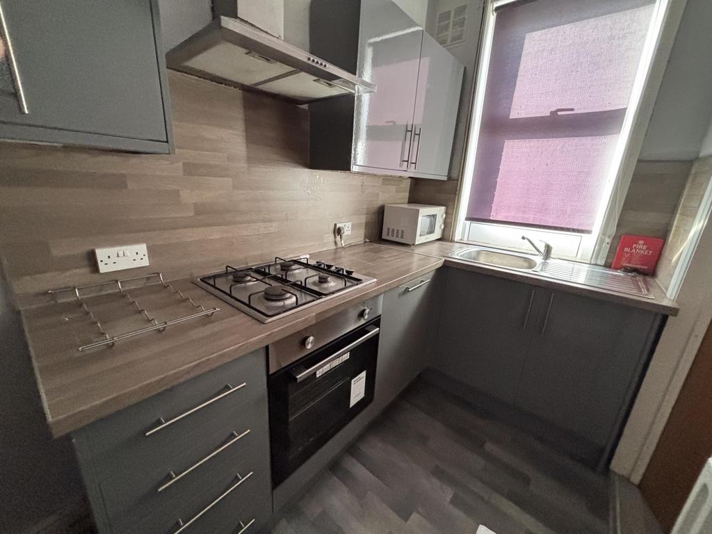 Bright and modern kitchen with ample counter sp...