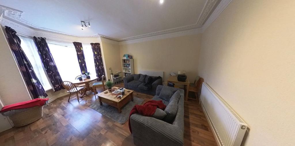 A bright and welcoming living room with large w...