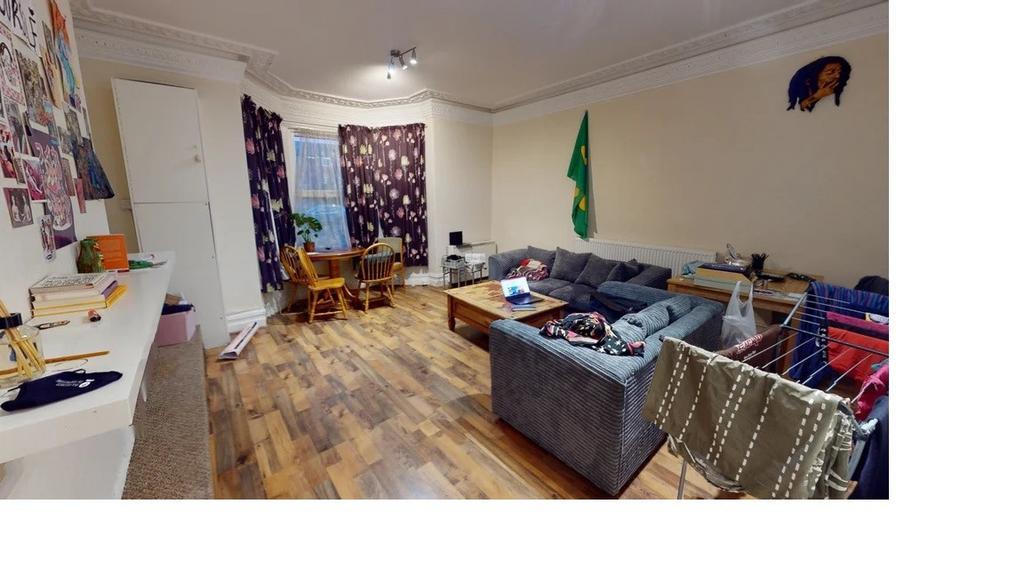 A spacious, well-lit living room with a large s...