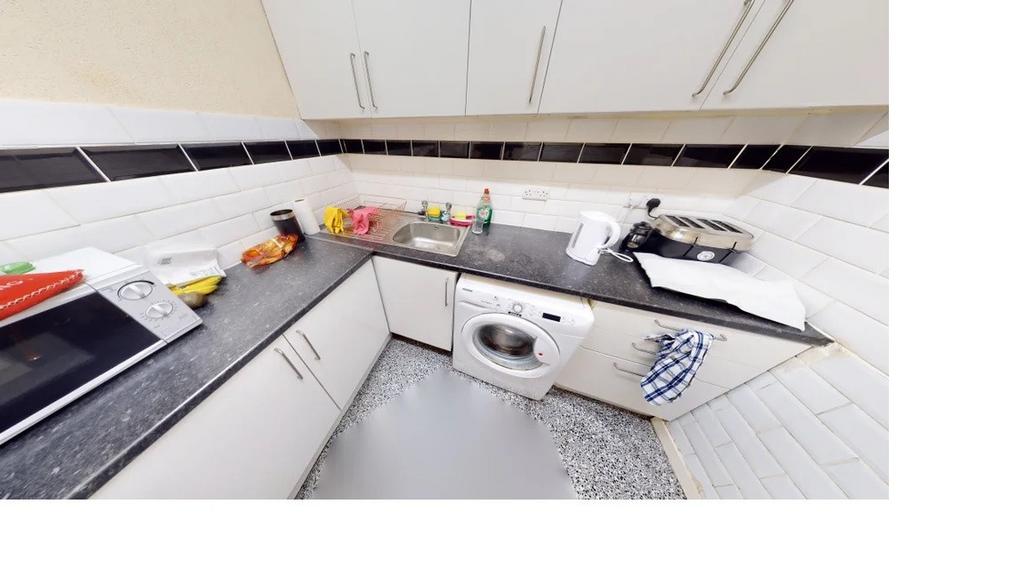 A modern, well-organized kitchen with ample wor...