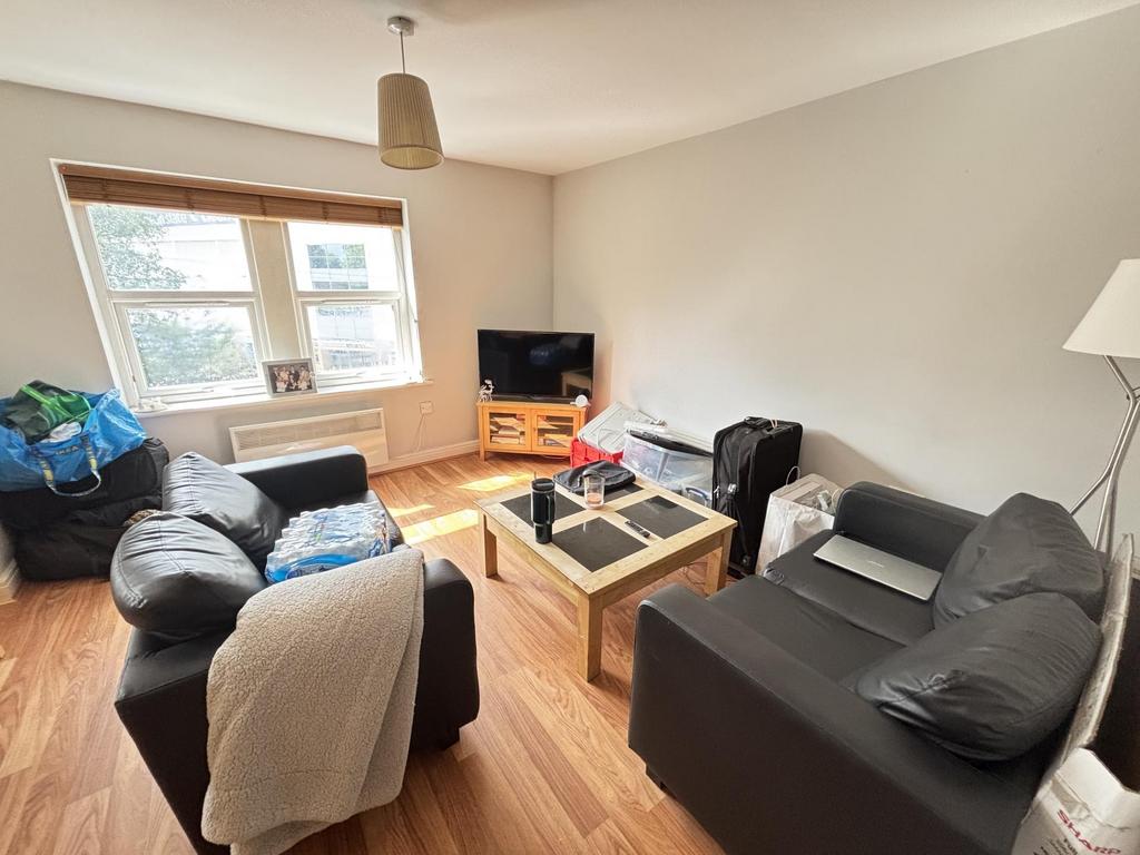A bright and welcoming living room featuring co...