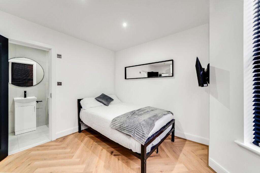 A clean and well-lit small bathroom featuring a...