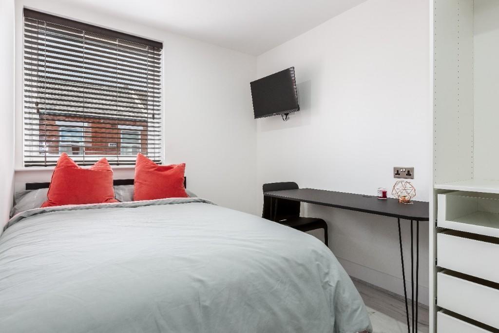 A bright and inviting double bedroom featuring ...