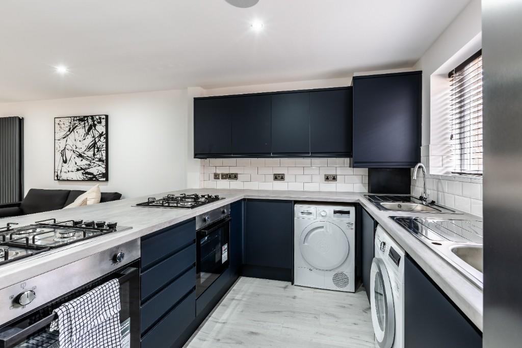 Modern kitchen with sleek blue cabinets, ample ...