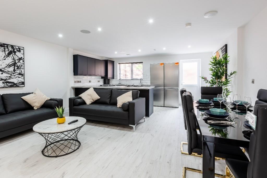 A spacious, modern living room featuring stylis...