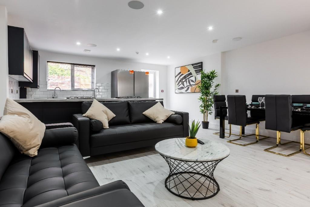 A modern, spacious living room with stylish bla...