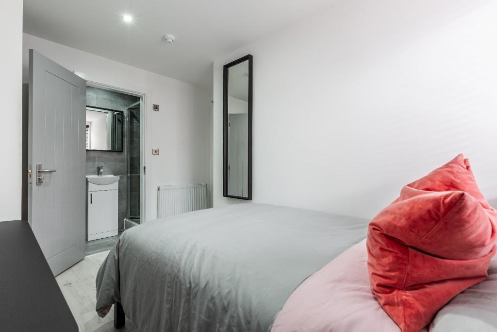 A modern and well-maintained master bedroom wit...