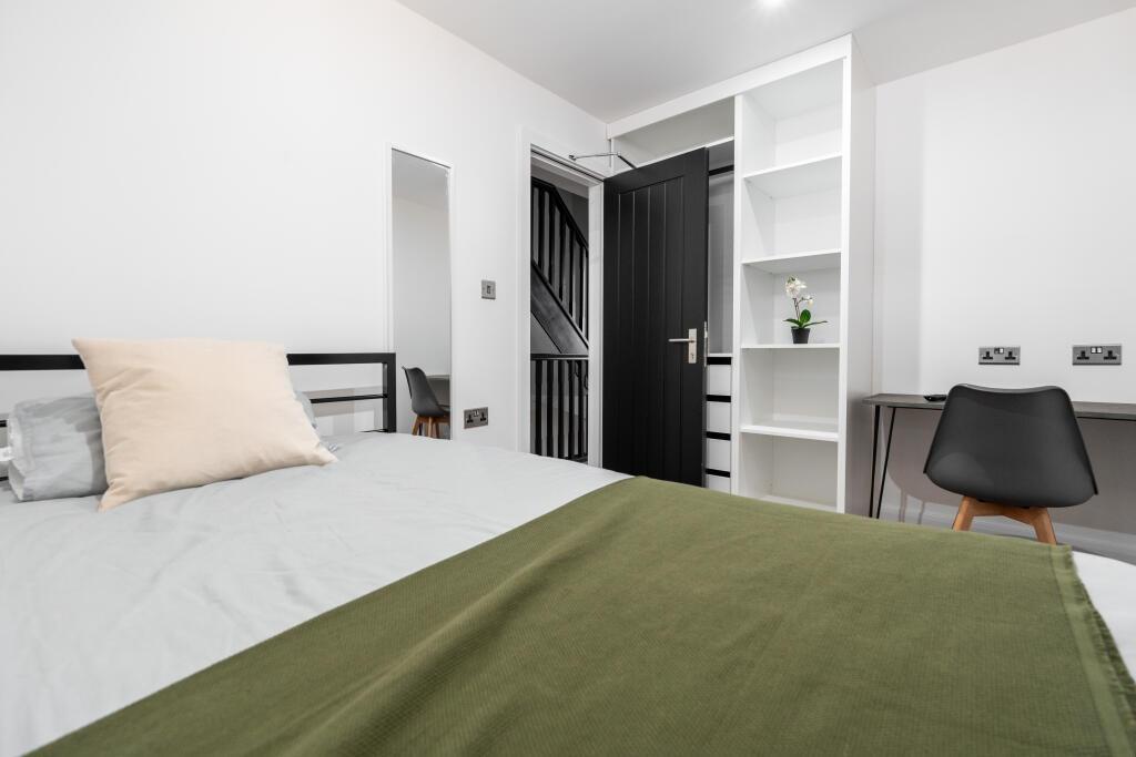 A bright and well-maintained master bedroom fea...