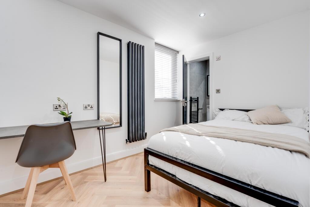 Bright and spacious master bedroom with natural...