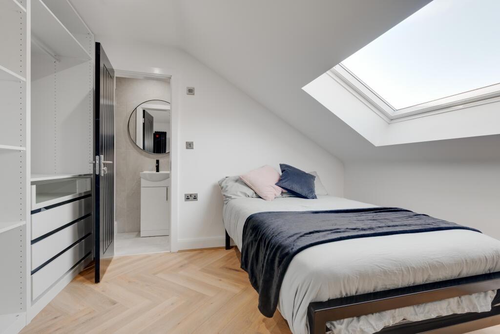 Bright and airy master bedroom with a comfortab...