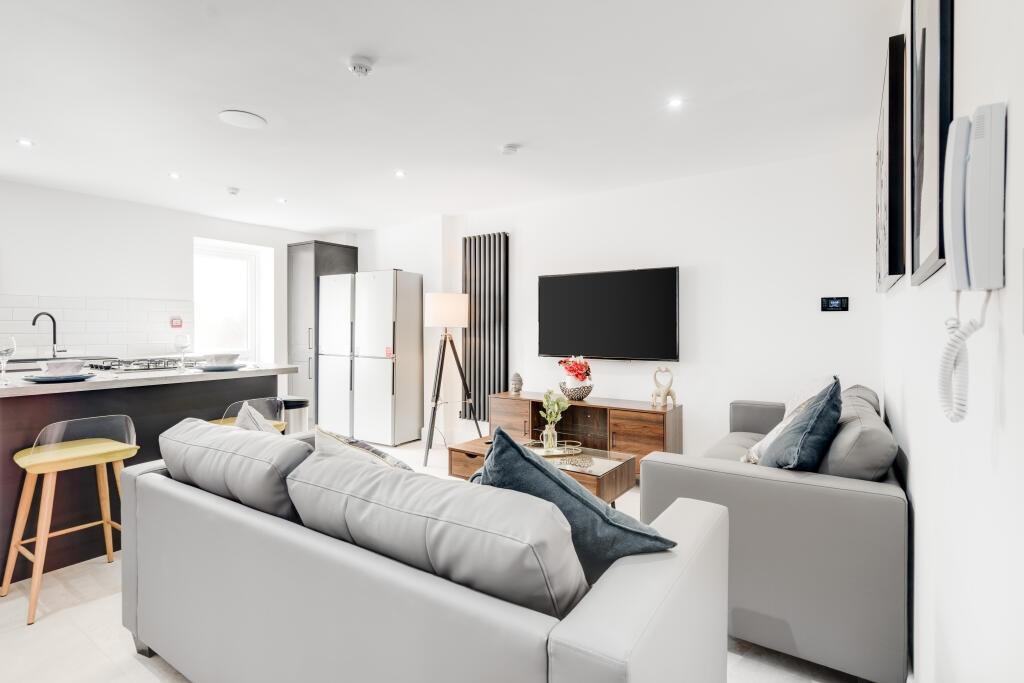 Bright and stylish contemporary living room fea...