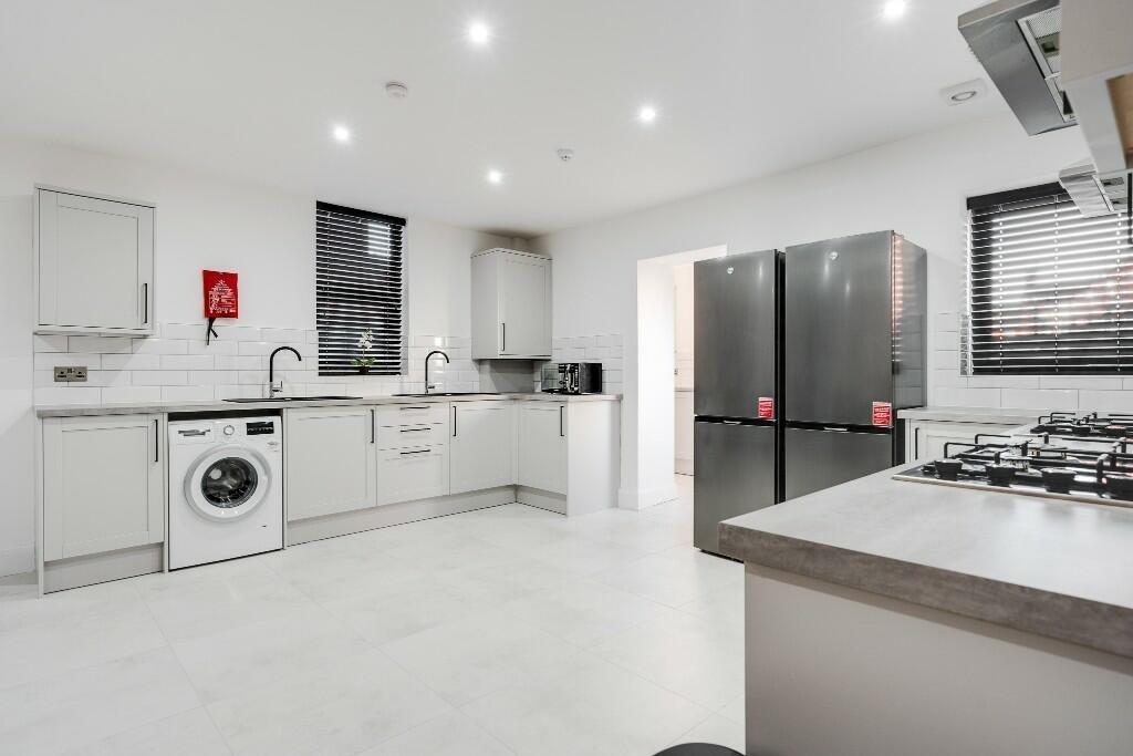 Bright and modern kitchen with ample workspace,...