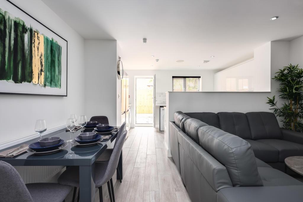 Bright and modern living room featuring comfort...