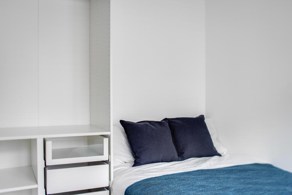 A cozy and well-maintained bedroom featuring a ...