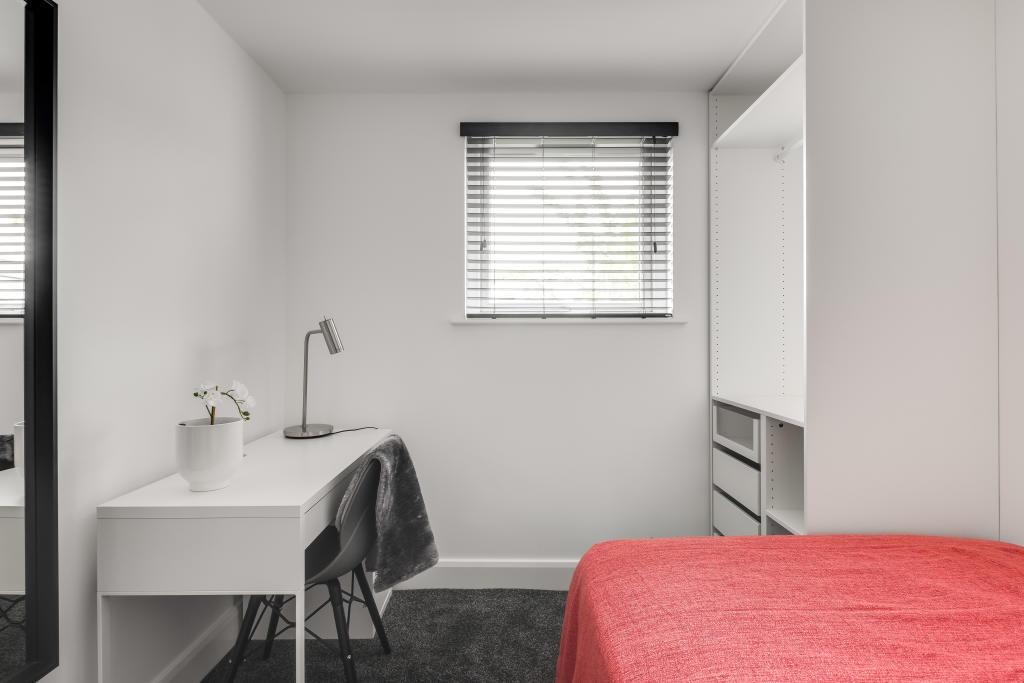 A clean, modern bathroom with a large bath and ...