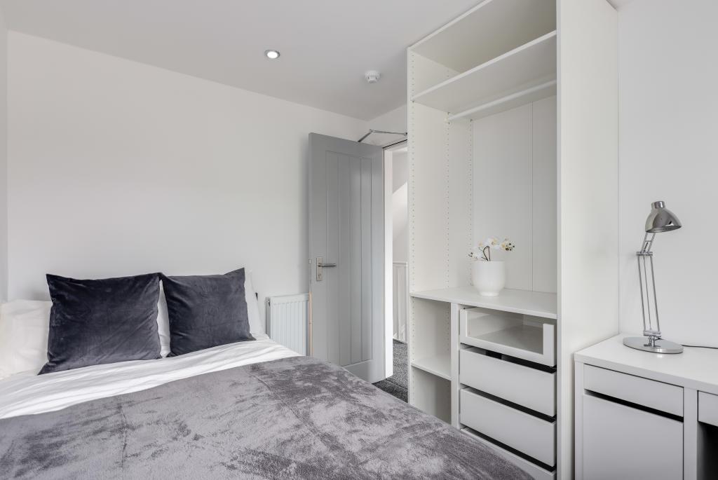 A modern, well-maintained bedroom featuring a c...