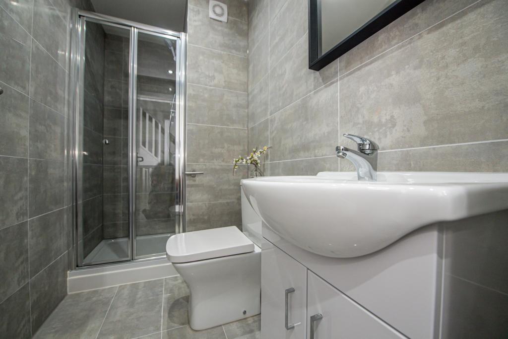 A modern, clean bathroom with a spacious shower...