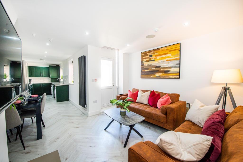 A bright, spacious living room featuring modern...