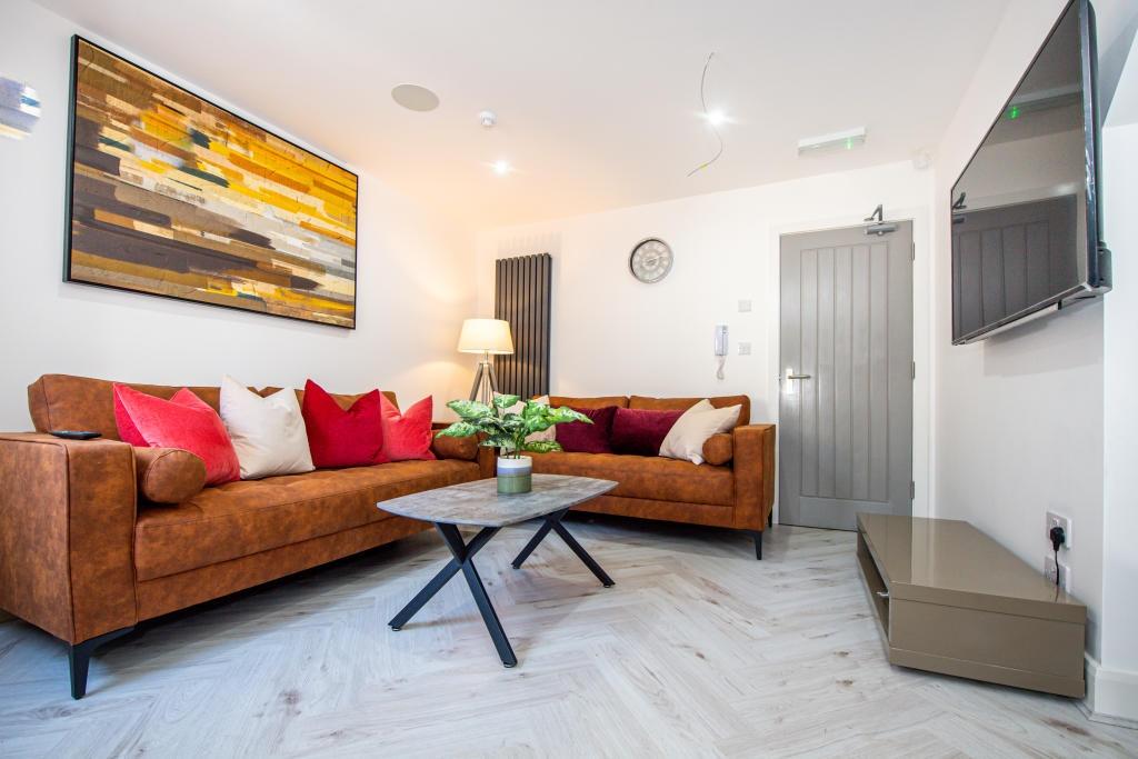 A bright and spacious living room featuring a c...