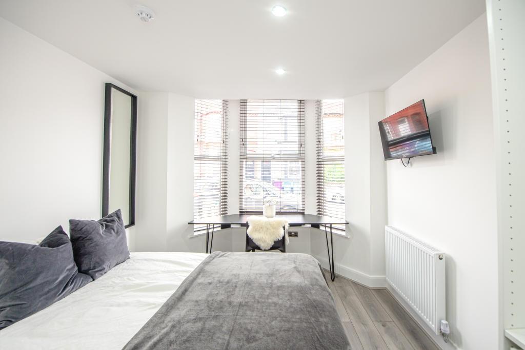 Bright and modern living room with large window...