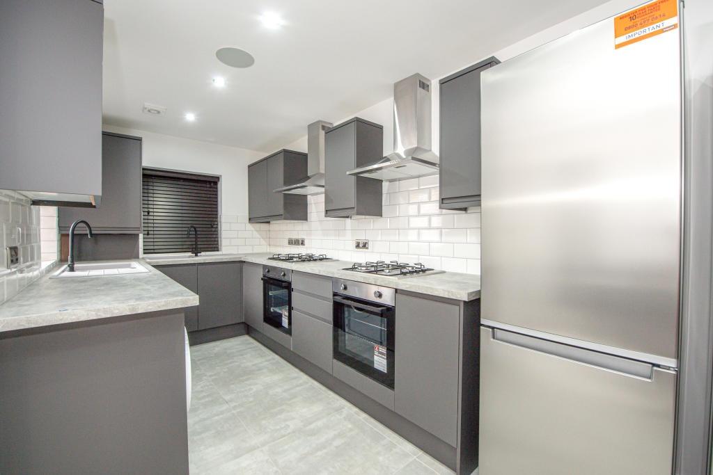 Modern, clean kitchen with sleek grey cabinetry...