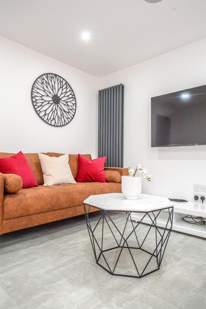 A modern, well-maintained living room with a la...