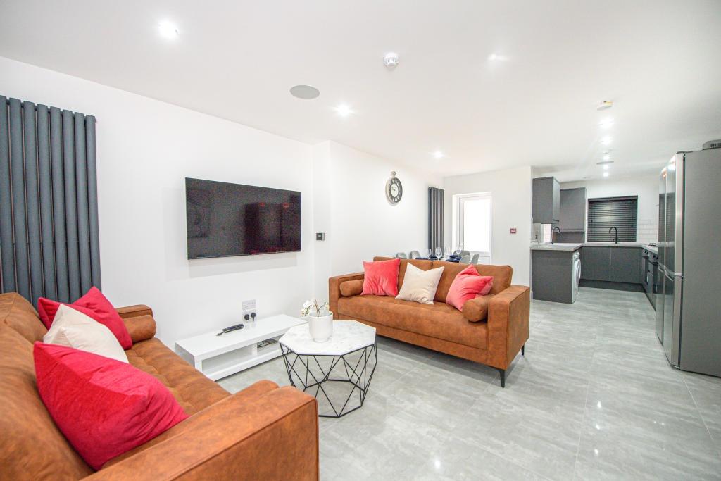 Bright and modern living room featuring comfort...