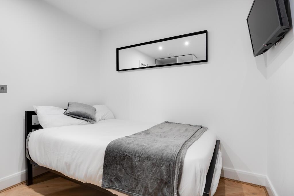 A well-maintained, modern master bedroom featur...