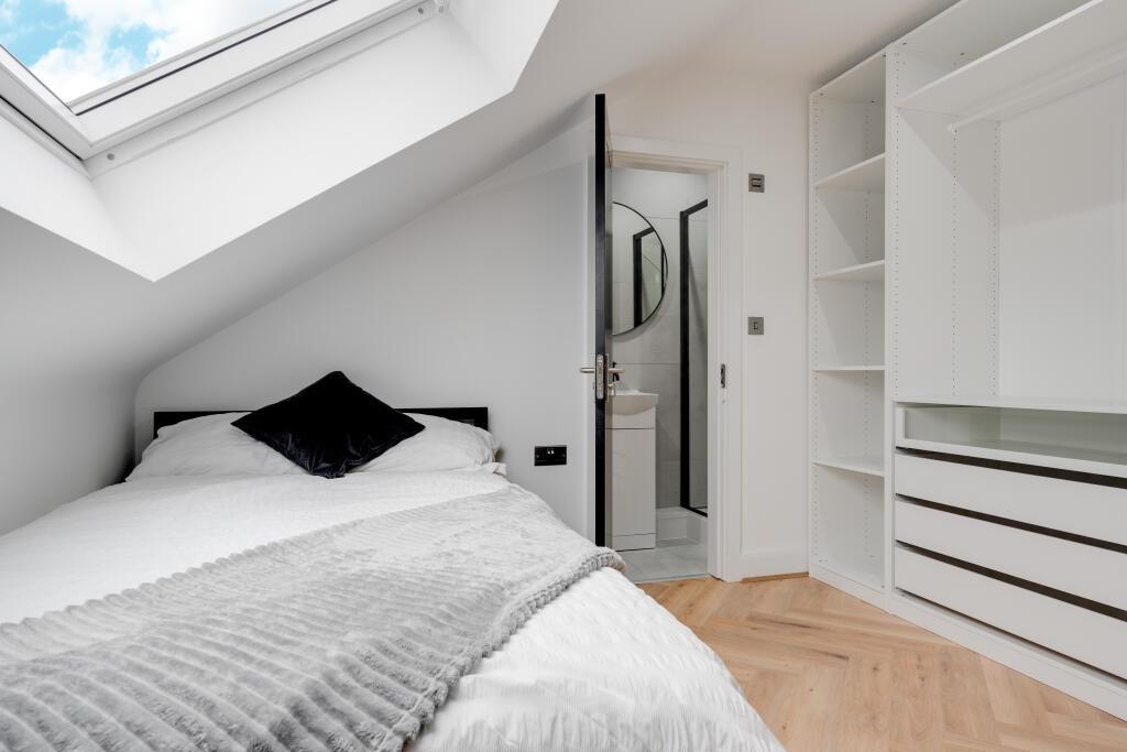 A bright and spacious master bedroom featuring ...