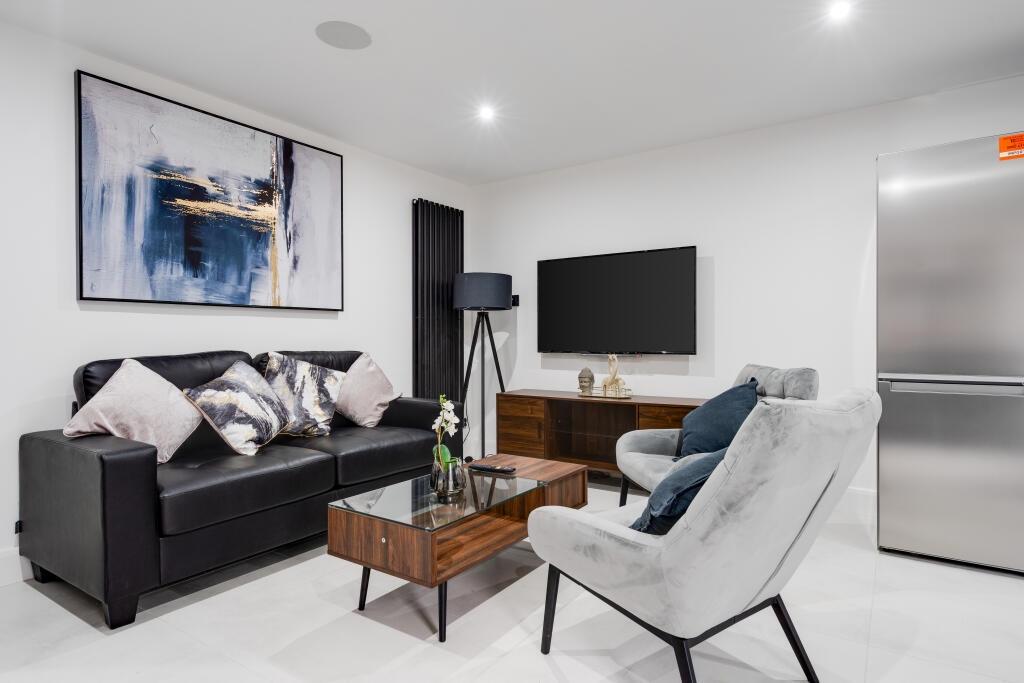 A modern, well-lit living room featuring a cont...