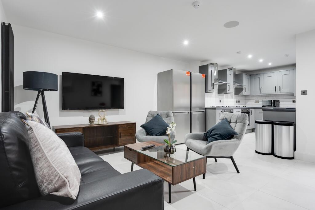 A modern and well-lit living room featuring sty...