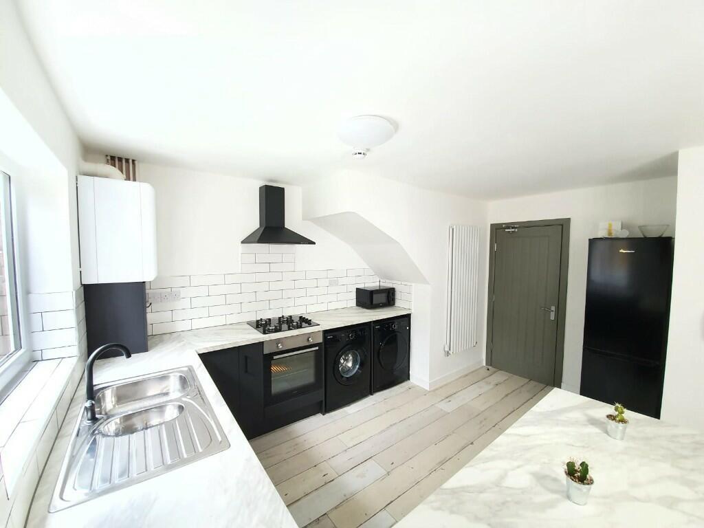 Bright and modern living room with ample natura...